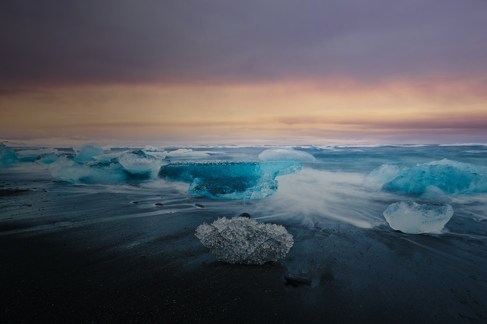 Long exposure of ice on beach at sunset