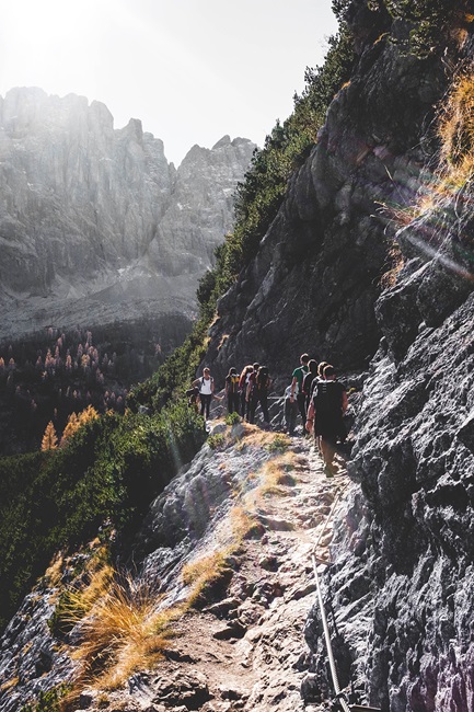 People hiking up side of mountain