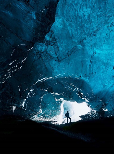 Person exploring a glacial cave in Iceland