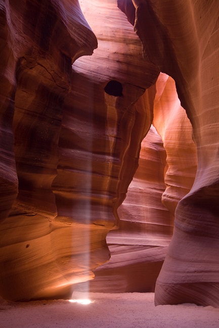 Beam of sunlight shinning down in cave