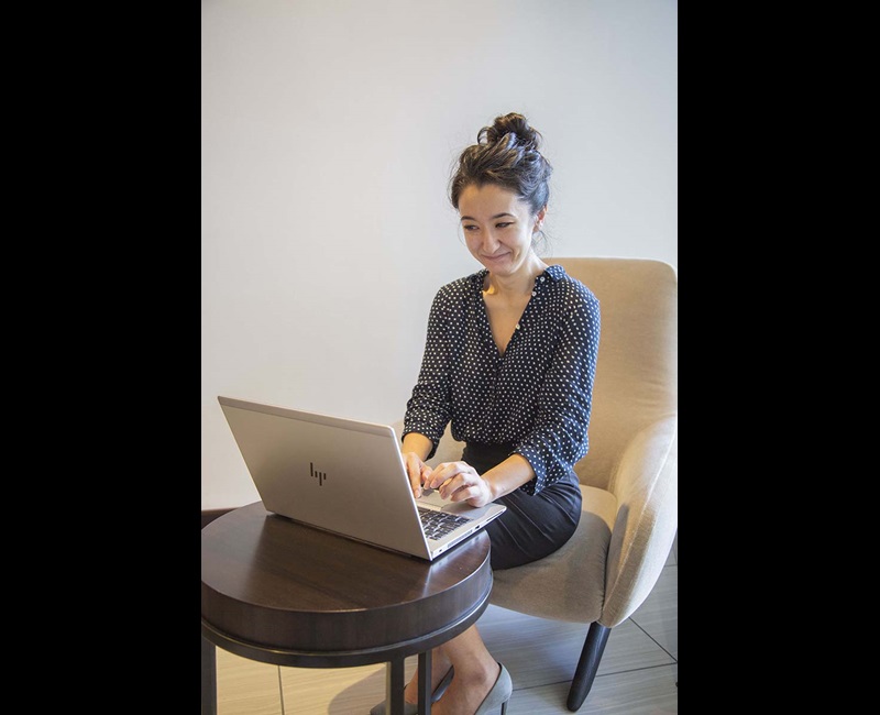 Woman smiling and typing on her computer Woman on computer