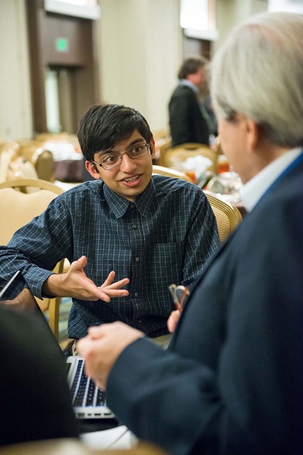 Young boy talking to elderly teacher