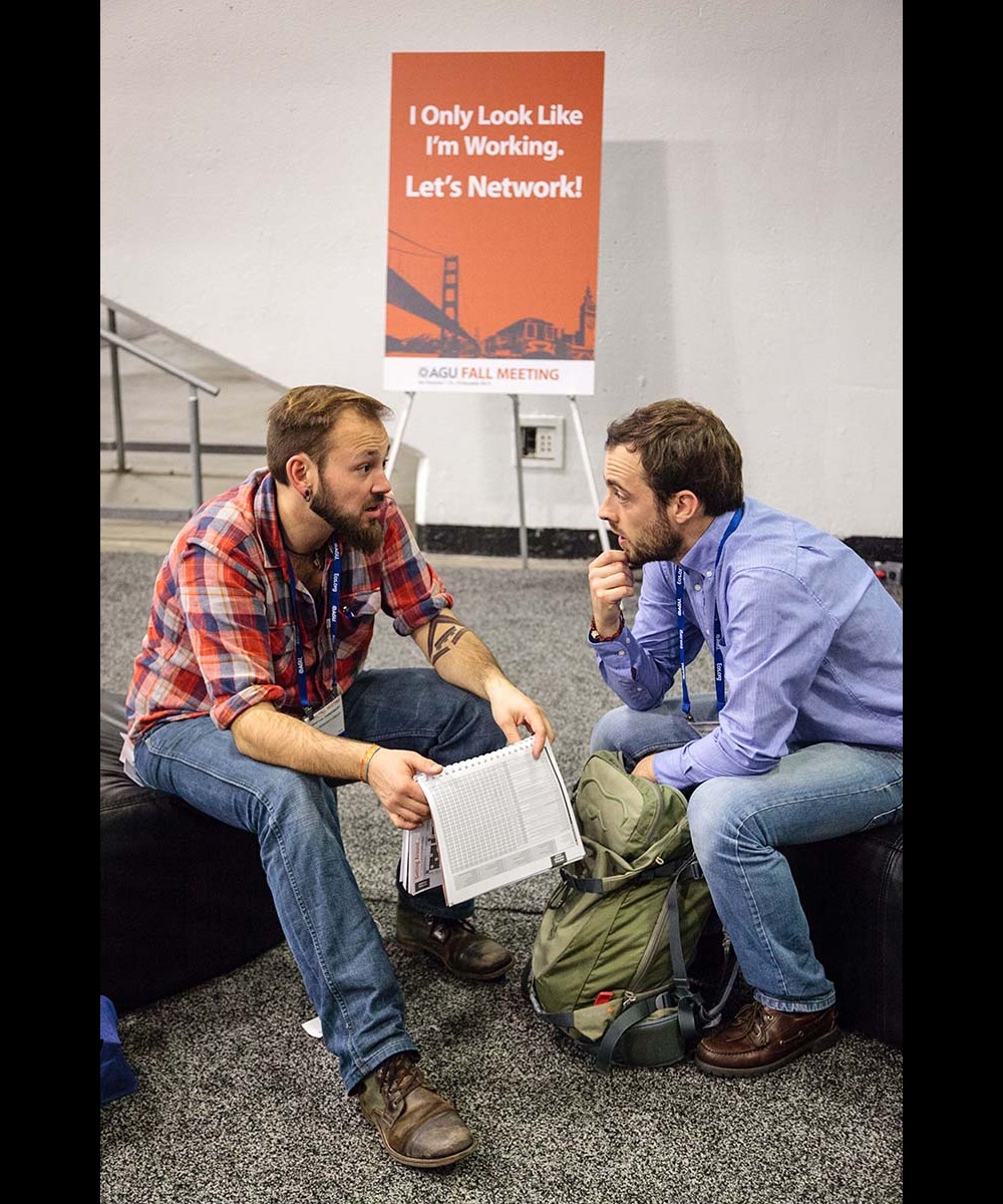 Two male adults sitting while having a conversation About Mentoring 365