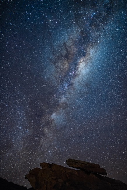 Silhouette rocks with stars above