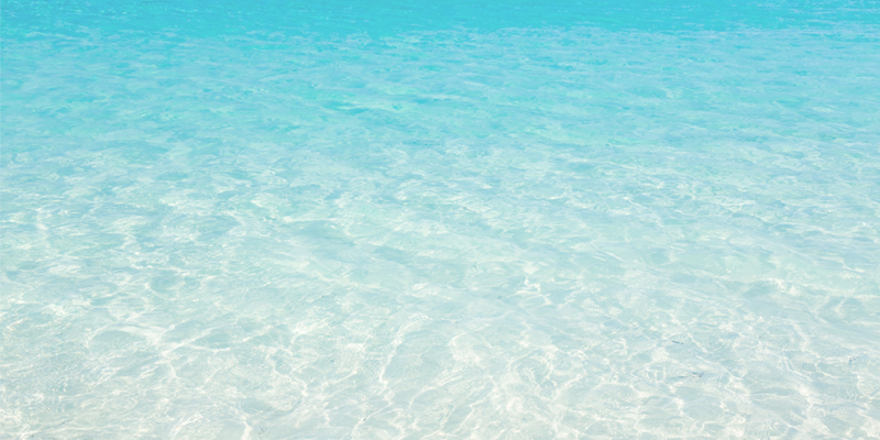 Aerial view of clear sunlit ocean waves